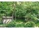Charming outbuildings nestled in lush greenery, adding character and functional space to the property at 5200A Burruss Mill Rd, Cumming, GA 30041