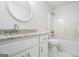 This bathroom features white cabinets, granite countertops, and a shower over the bathtub at 115 Stewart Hollow Ln, Covington, GA 30016