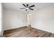 Bedroom with hardwood floors, ceiling fan, closet and doorway to ensuite bathroom at 115 Stewart Hollow Ln, Covington, GA 30016