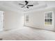 Spacious bedroom features a tray ceiling, carpet, and bright natural light at 115 Stewart Hollow Ln, Covington, GA 30016