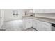 Bright kitchen with granite countertops, white cabinetry and decorative pendant lighting at 115 Stewart Hollow Ln, Covington, GA 30016