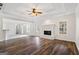 Open concept living room with hardwood floors, fireplace and many windows at 115 Stewart Hollow Ln, Covington, GA 30016