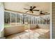 Relaxing screened porch with ceiling fans, perfect for enjoying outdoor living at 115 Stewart Hollow Ln, Covington, GA 30016