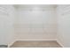 Carpeted walk-in closet with multiple shelves for optimal storage at 115 Stewart Hollow Ln, Covington, GA 30016