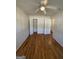 Bright bedroom features hardwood flooring, a ceiling fan, and fresh neutral paint at 1988 Bencal Se Dr, Atlanta, GA 30316