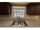 A kitchen sink with countertops and a window with a view of the backyard at 1988 Bencal Se Dr, Atlanta, GA 30316
