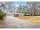 Ranch home with long driveway and 2-car attached garage and well-manicured landscaping in a beautiful park-like setting at 334 Nancy Sw Ct, Lilburn, GA 30047