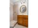 Bathroom with tan tile walk-in shower, tile floor and a wooden vanity with a bright, gold-framed mirror at 334 Nancy Sw Ct, Lilburn, GA 30047