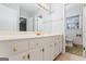Long white vanity with double sinks, gold hardware, and lots of storage space, plus a peek into the water closet at 334 Nancy Sw Ct, Lilburn, GA 30047