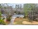 Charming single-story home with mature landscaping, an attached two car garage, and a long driveway at 334 Nancy Sw Ct, Lilburn, GA 30047