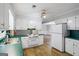 Well-lit kitchen boasts white appliances, green counters, and connection to the living room at 334 Nancy Sw Ct, Lilburn, GA 30047