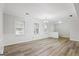 Bright, open-concept living room features hardwood floors and modern fixtures at 334 Nancy Sw Ct, Lilburn, GA 30047