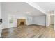 Living room with brick fireplace, hardwood flooring, and views of kitchen at 334 Nancy Sw Ct, Lilburn, GA 30047