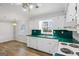 Functional kitchen featuring white cabinets, green countertops, and modern appliances at 334 Nancy Sw Ct, Lilburn, GA 30047