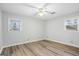 This bedroom features neutral paint and wood-look flooring, plus natural light from the double-window at 334 Nancy Sw Ct, Lilburn, GA 30047