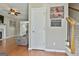 Inviting entryway with hardwood floors leading to the staircase and a view of the living area at 208 Clifton Ln, Peachtree City, GA 30269