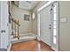 Bright foyer featuring hardwood floors, a staircase, and a white front door with sidelights at 208 Clifton Ln, Peachtree City, GA 30269