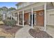 Inviting brick-lined porch with white pillars and a cozy outdoor seating area at 208 Clifton Ln, Peachtree City, GA 30269