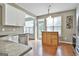 A sunlit area with white cabinets, stainless steel appliances, lots of counter space and a kitchen island at 208 Clifton Ln, Peachtree City, GA 30269