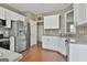 A spacious kitchen area featuring white cabinets, stainless steel appliances, and lots of counter space at 208 Clifton Ln, Peachtree City, GA 30269