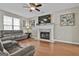 Comfortable living room featuring hardwood floors, a fireplace, and comfortable seating at 208 Clifton Ln, Peachtree City, GA 30269