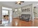 Open-concept living area flowing into the dining room, featuring hardwood floors and neutral decor at 208 Clifton Ln, Peachtree City, GA 30269