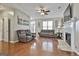 Spacious living room showcasing hardwood floors, neutral walls, and comfortable reclining sofas at 208 Clifton Ln, Peachtree City, GA 30269