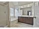 This primary bathroom features neutral walls, tile floors, a double sink vanity, a shower, and a tub at 208 Clifton Ln, Peachtree City, GA 30269