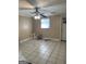 Bedroom featuring tile floors, window, ceiling fan and a white door at 287 Henry Aaron Sw Ave, Atlanta, GA 30310
