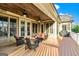 Enjoy the outdoors on this cozy covered back porch with a wood ceiling and outdoor seating at 545 Mountains Edge, Peachtree City, GA 30269