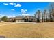 Attractive single-story home with a three-car garage, front porch, and a circular driveway at 545 Mountains Edge, Peachtree City, GA 30269