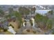 An aerial view of a stately home with a circular driveway and a scenic lake nearby at 256 Allie Dr, Mcdonough, GA 30252