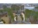 An aerial view of a stately home with a circular driveway and a scenic lake nearby at 256 Allie Dr, Mcdonough, GA 30252