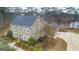 Aerial view of large home with a big driveway, manicured landscape and lake in the back at 256 Allie Dr, Mcdonough, GA 30252