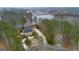 An aerial view of a stately home with a circular driveway and a scenic lake nearby at 256 Allie Dr, Mcdonough, GA 30252