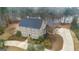 Aerial view of large home with a big driveway, manicured landscape and lake in the back at 256 Allie Dr, Mcdonough, GA 30252