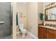 Bathroom featuring vanity with dark wood cabinets and a tiled shower at 256 Allie Dr, Mcdonough, GA 30252