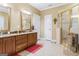Bathroom featuring double vanity, glass shower and tiled floors at 256 Allie Dr, Mcdonough, GA 30252
