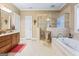 Spacious bathroom with a soaking tub, glass-enclosed shower, and tiled flooring at 256 Allie Dr, Mcdonough, GA 30252