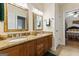 Bathroom features a double vanity with granite counters and dark wood cabinets at 256 Allie Dr, Mcdonough, GA 30252