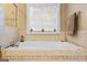 Close up shot of the bathtub with tile surround, and window above at 256 Allie Dr, Mcdonough, GA 30252