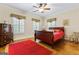 Bedroom featuring a bed, shuttered windows, a ceiling fan and hardwood floors at 256 Allie Dr, Mcdonough, GA 30252