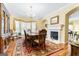 Formal dining room with elegant chandelier, fireplace, and large windows at 256 Allie Dr, Mcdonough, GA 30252