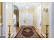Elegant foyer featuring hardwood floors, arched doorways, and a stylish rug leading into the home at 256 Allie Dr, Mcdonough, GA 30252