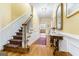 Elegant foyer with a staircase, hardwood floors, and classic decor creates a grand and welcoming entrance at 256 Allie Dr, Mcdonough, GA 30252