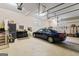 Bright garage with high ceilings, storage, and parking space for car with attached tool area at 256 Allie Dr, Mcdonough, GA 30252