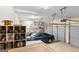 Well-lit three car garage space with storage shelving and high ceilings at 256 Allie Dr, Mcdonough, GA 30252