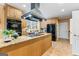 Kitchen featuring black appliances, range hood, and tile flooring at 256 Allie Dr, Mcdonough, GA 30252