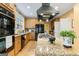 Kitchen featuring black appliances, range hood, and tile flooring at 256 Allie Dr, Mcdonough, GA 30252