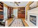 Cozy library features built-in bookshelves and a fireplace at 256 Allie Dr, Mcdonough, GA 30252